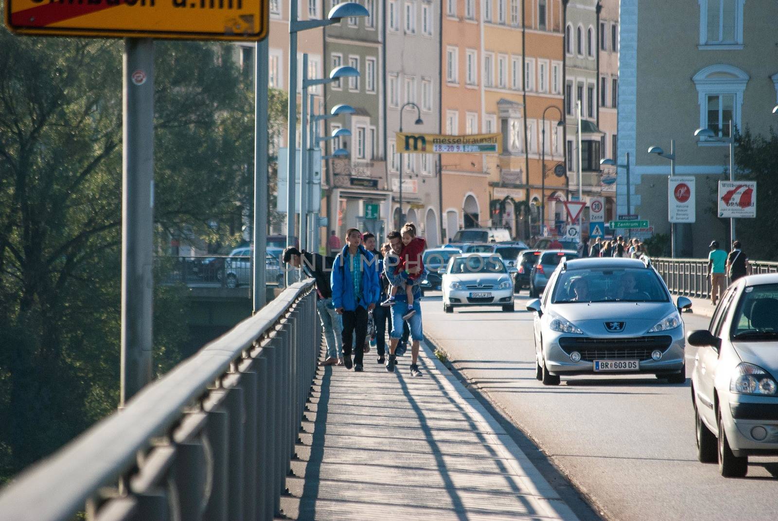 GERMANY, Simbach am Inn: Refugees walk on a bridge and cross the border from Austria to Germany in order to join Simbach am Inn, in south-eastern Germany on September 17, 2015; 