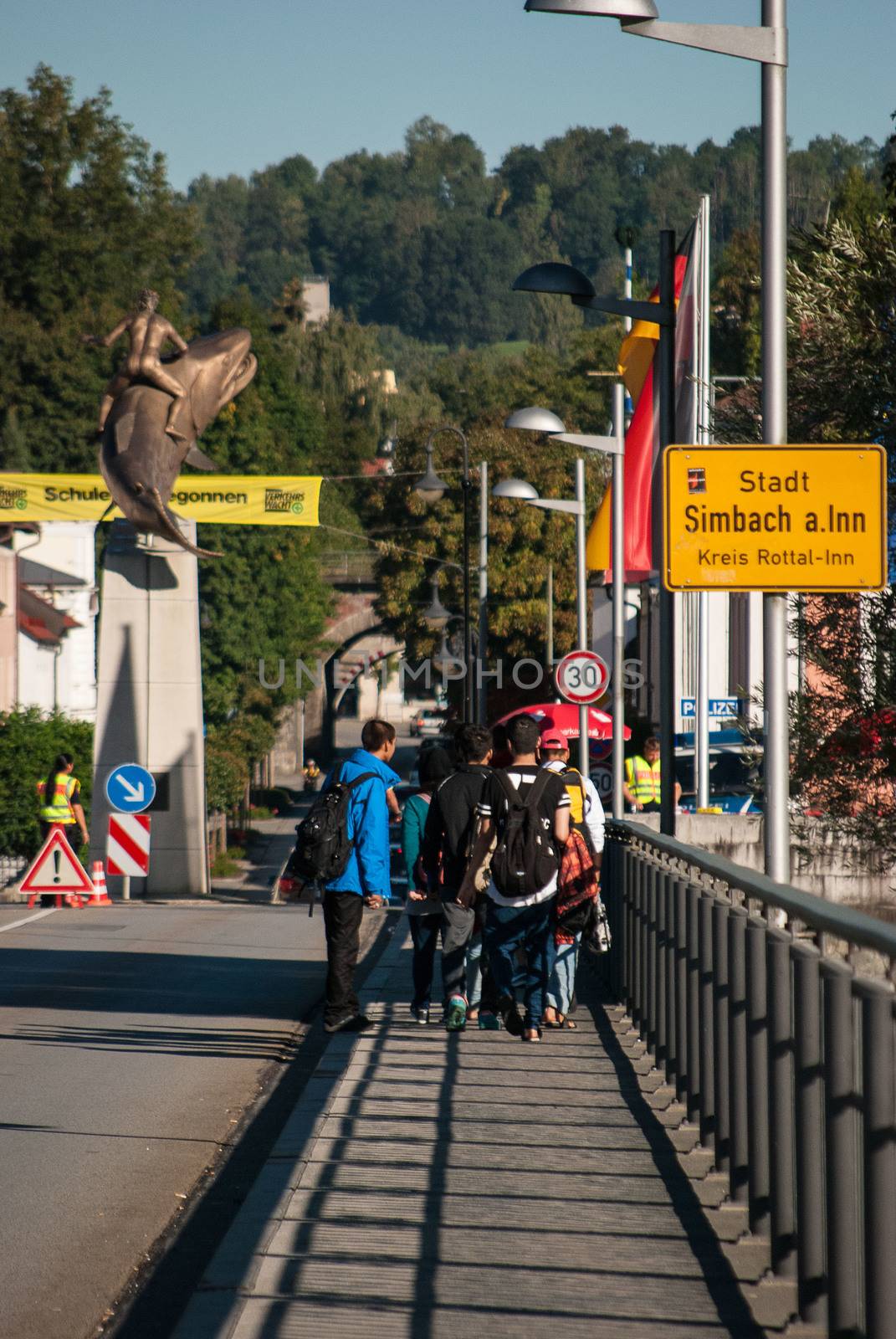 GERMANY, Simbach am Inn: Refugees walk on a bridge and cross the border from Austria to Germany in order to join Simbach am Inn, in south-eastern Germany on September 17, 2015.  