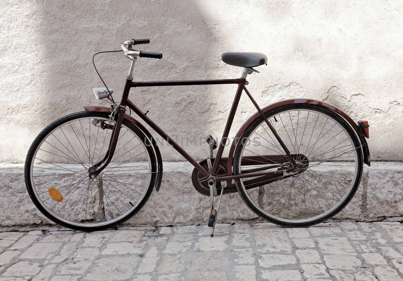 old bicycle against wall, old postcard toning