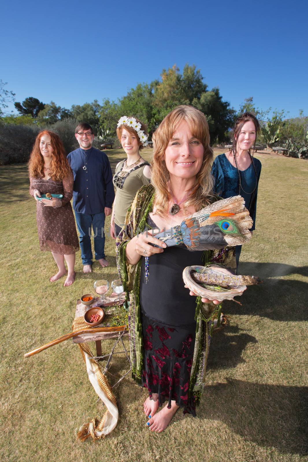 Male and female pagan group with sage incense