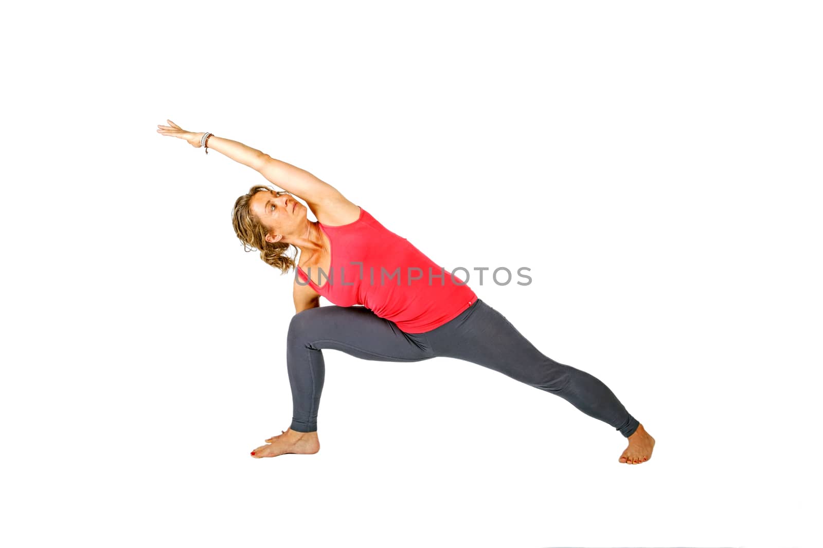 Young woman making a yoga posture on a white background by devy