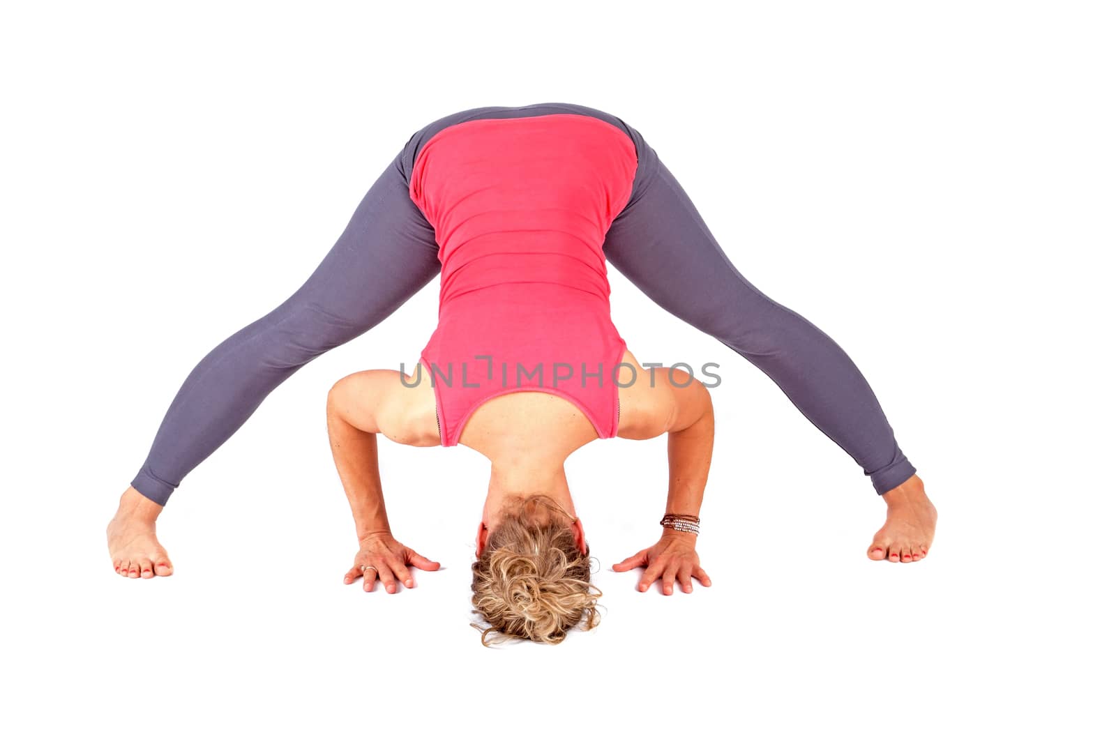 Young woman making a yoga posture on a white background