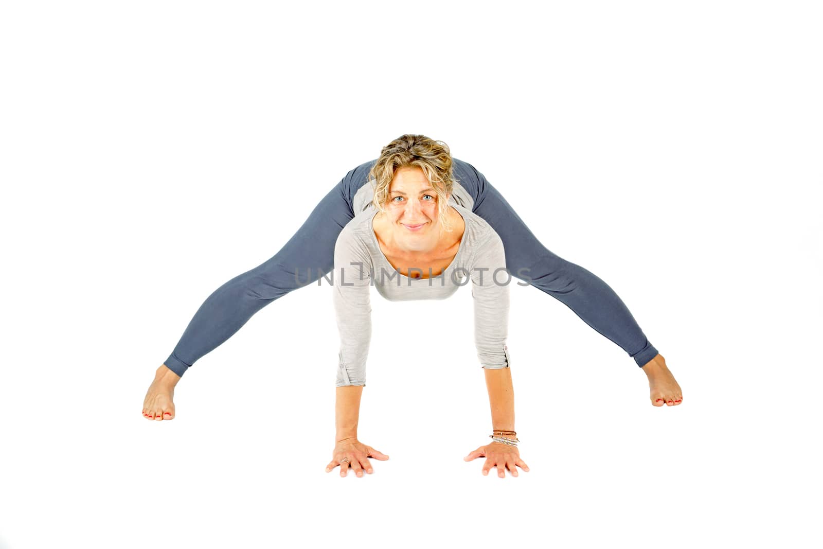 Young woman making a yoga posture on a white background by devy
