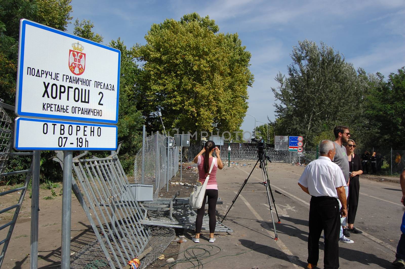 SERBIA, Horgo�: Members of the press take pictures of the razor-wire fence at the Serbia-Hungary border in Horgo�, Serbia on September 17, 2015. Recently the migrants have clashed with police forcing the police to use tear gas and water cannons to hold the refugees at bay. The migrants demanded that the razor-wire fence be opened, which would allow them to continue their journey though Europe. 