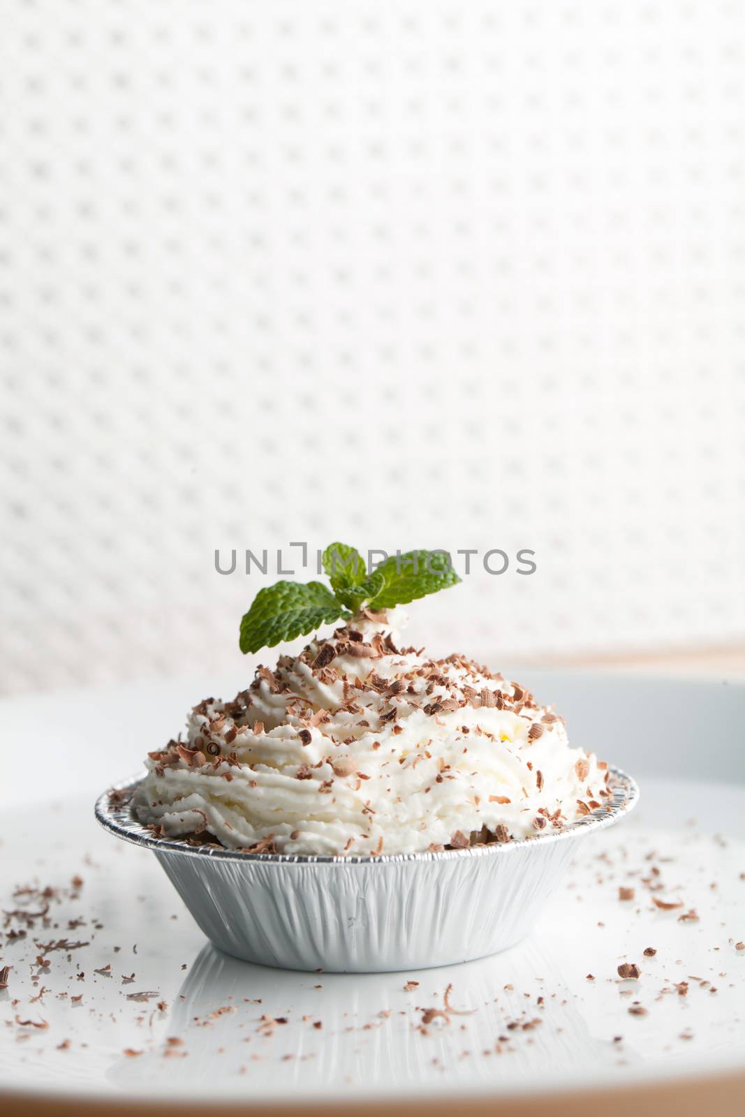 Parfait dessert with fresh whipped cream and chocolate shavings. Shallow depth of field.