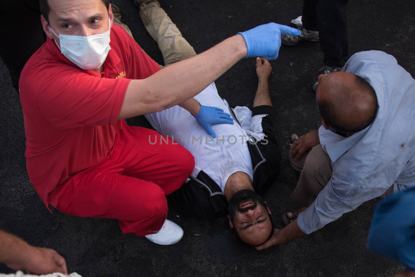 SERBIA, Horgos: A man is treated for injuries as Hungarian riot police clash with refugees waiting to cross the border from the Serbian border town of Horgos on September 16, 2015. 