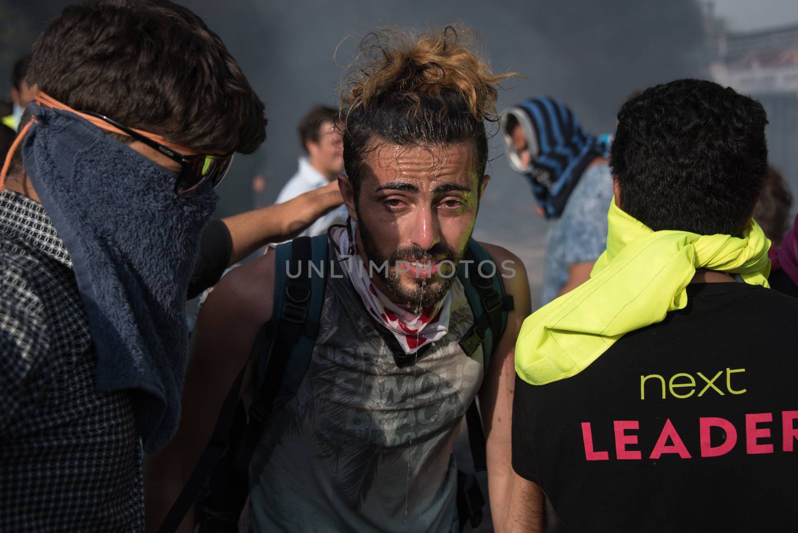 SERBIA, Horgos: Protesters suffer the effects of tear gas as Hungarian riot police clash with refugees waiting to cross the border from the Serbian border town of Horgos on September 16, 2015. 