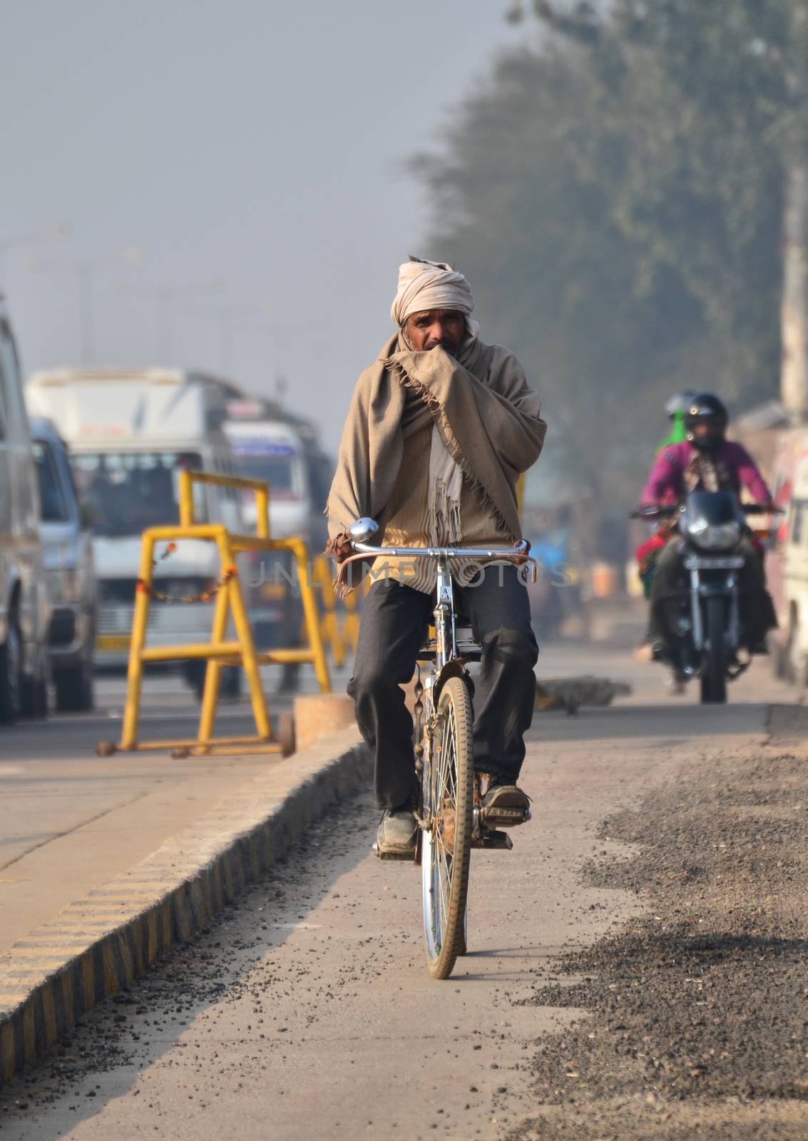 Jaipur, India - December 30, 2014: Indian people riding a bicycle in Jaipur, Rajasthan, India on December 29, 2014 . Jaipur is the capital and largest city of the Indian state of Rajasthan in Northern India