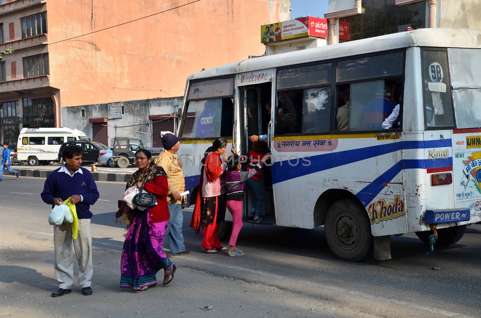 Jaipur, India - December 30, 2014: Indian people taking a bus in Jaipur by siraanamwong