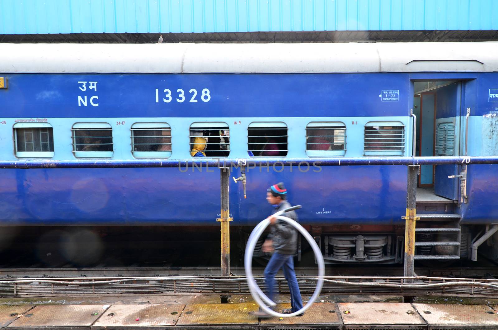 Jaipur, India - January 3, 2015: passengers at the window of a Indian Railway train at the railway station of Jaipur, Rajasthan, India. Indian Railways carries about 7,500 million passengers annually.