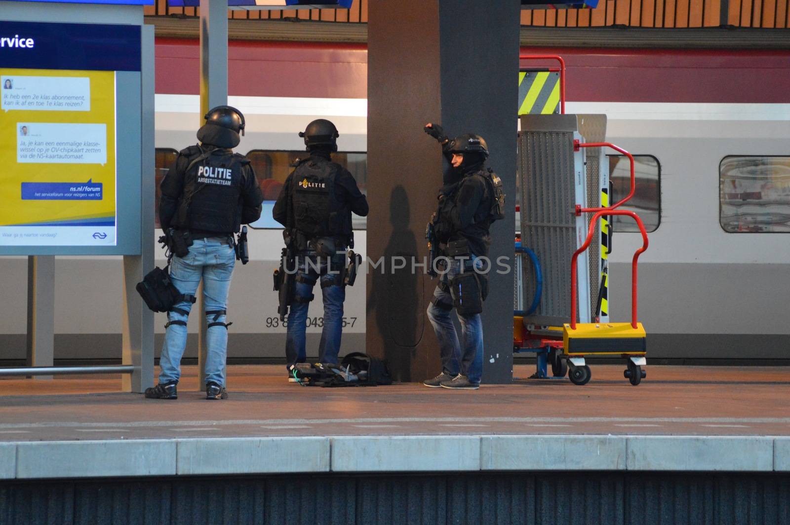 NETHERLANDS, Rotterdam: Members of a special unit of Dutch police stand guard near a Thalys train on a platform of Rotterdam central station, on September 18, 2015, as a man has locked himself in the train'sbathroom. The Thalys plus several platforms have been evicted.