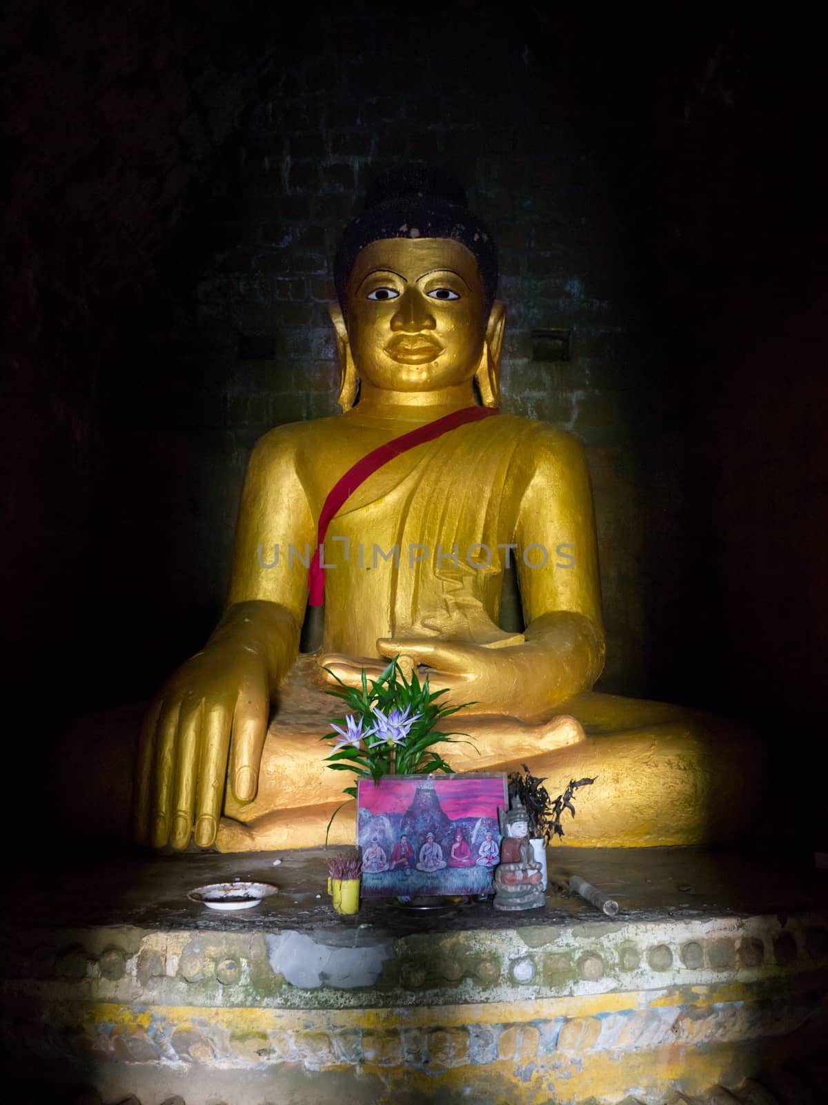 Buddha image in dark krypt in Mrauk U, Rakhine State in Myanmar.