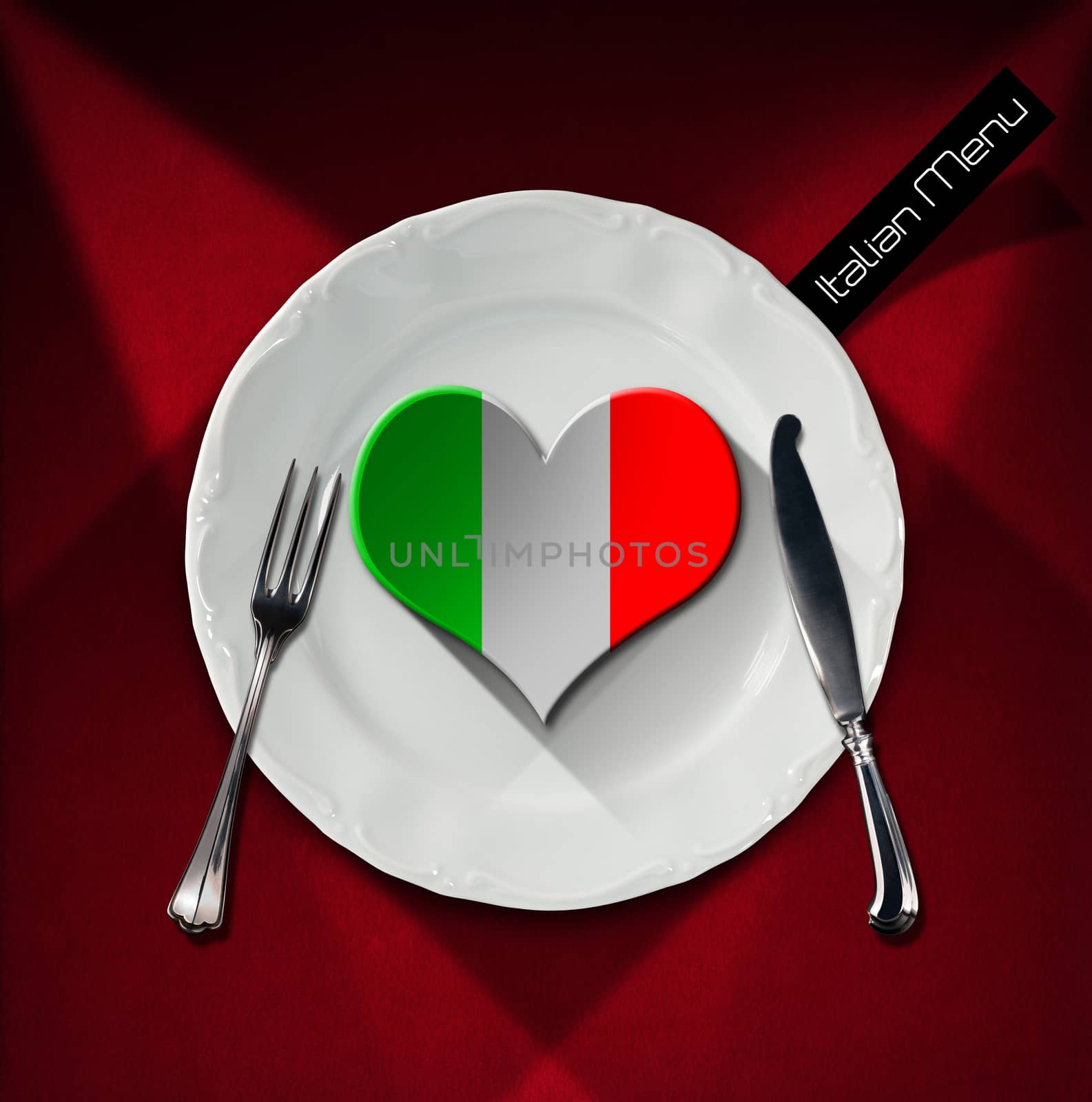 Green, white and red heart on a white plate with silver cutlery on red velvet background with shadows. Concept of healthy italian food