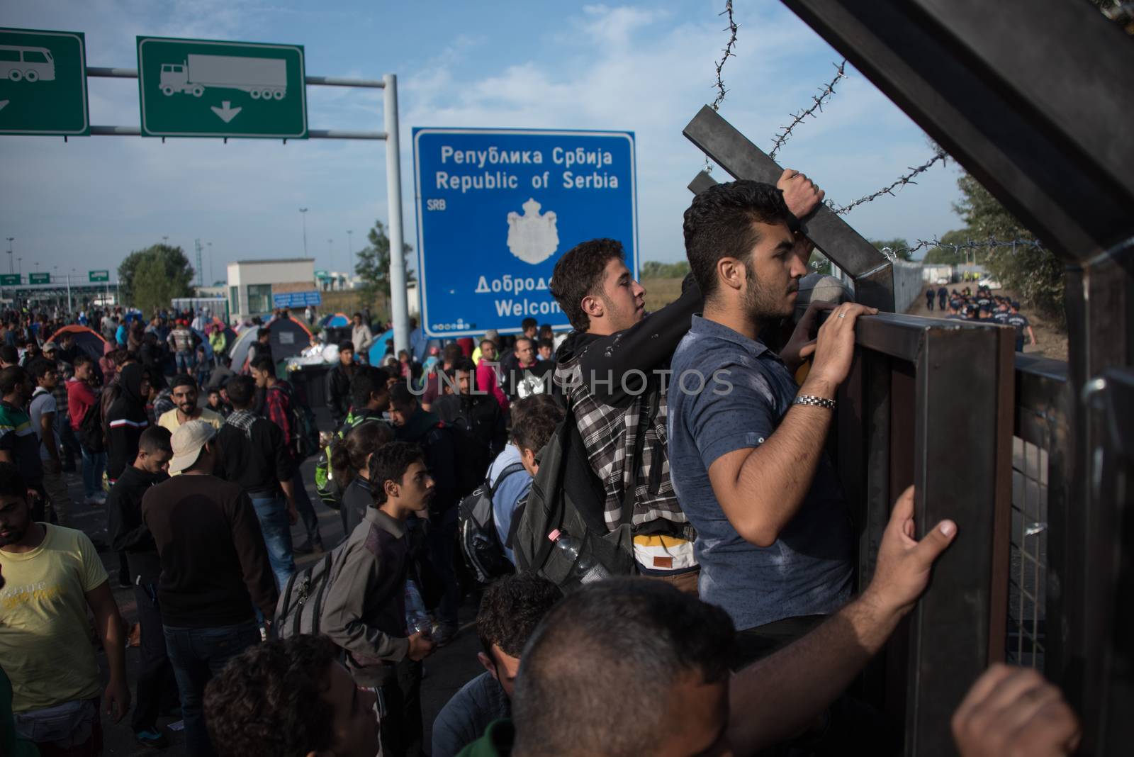 SERBIA, Horgos: Hungarian riot police clash with refugees waiting to cross the border from the Serbian border town of Horgos on September 16, 2015. 