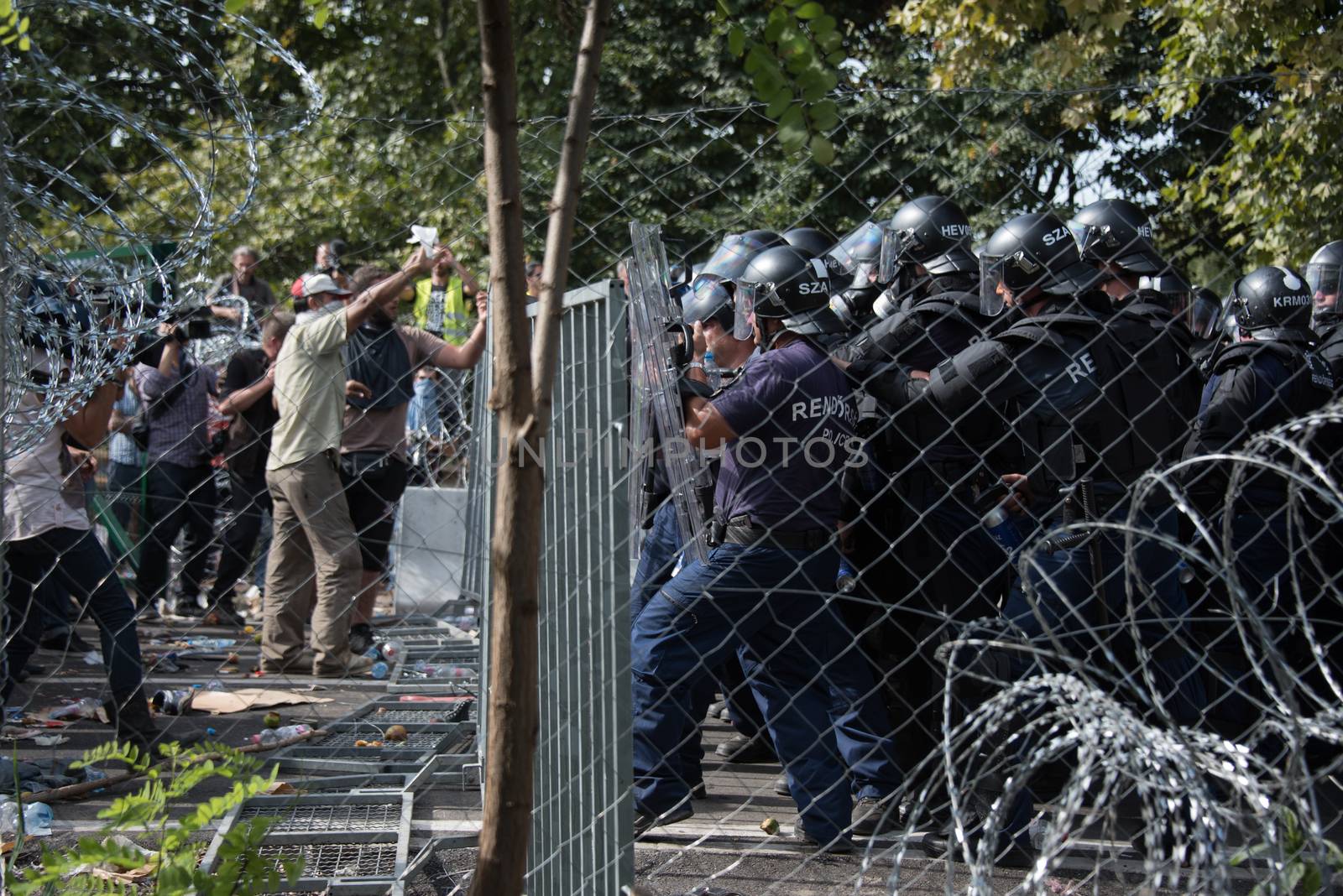 SERBIA, Horgos: Hungarian riot police clash with refugees waiting to cross the border from the Serbian border town of Horgos on September 16, 2015. 