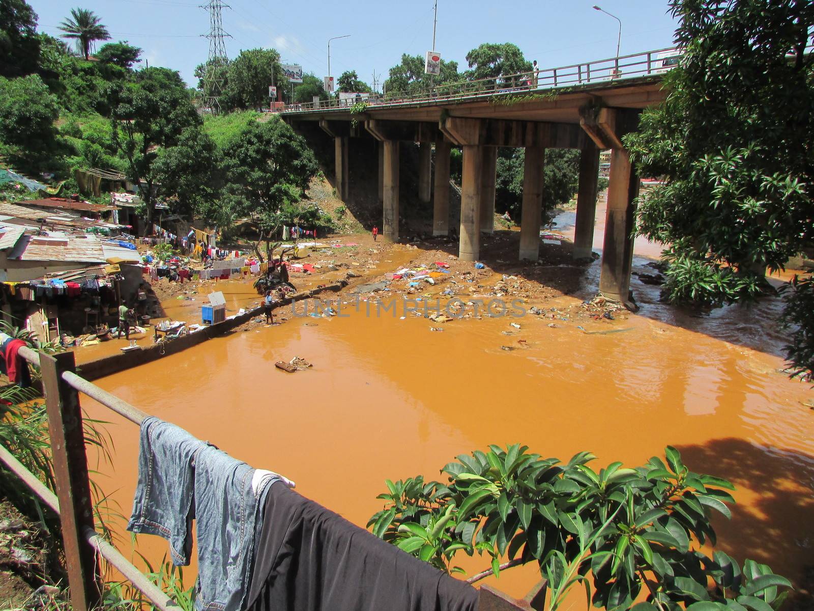 SIERRA LEONE, Freetown: Severe flooding that hit Freetown, Sierra Leone this week has left four people dead and is posing a serious risk of Ebola spreading. Residents at Congo Cross Bridge worked to dry out their homes and contain the spread of the disease on September 17, 2015. 