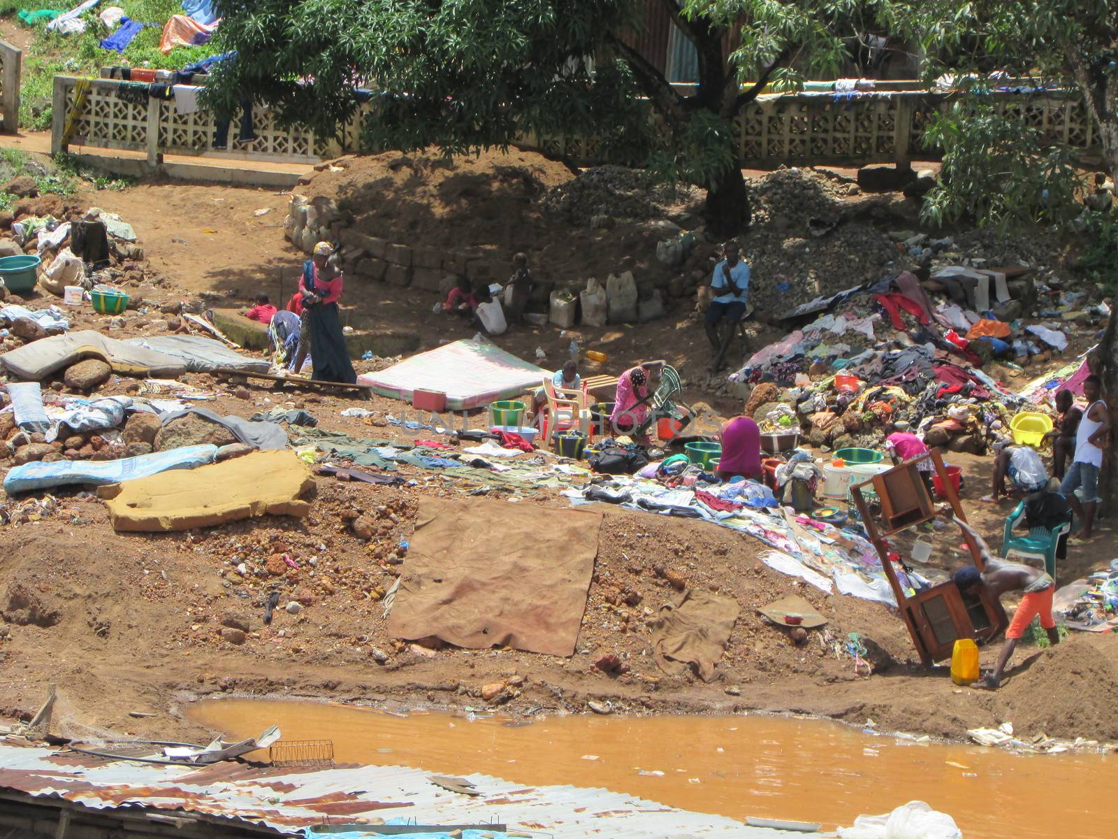 SIERRA LEONE, Freetown: Severe flooding that hit Freetown, Sierra Leone this week has left four people dead and is posing a serious risk of Ebola spreading. Residents at Congo Cross Bridge worked to dry out their homes and contain the spread of the disease on September 17, 2015. 