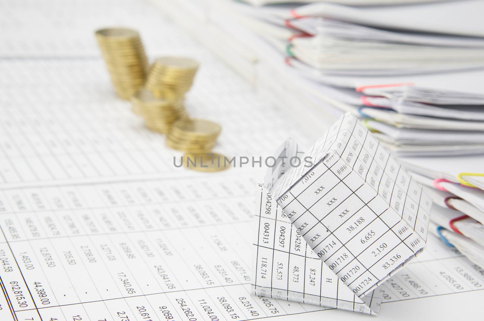 Close up bankruptcy of house on finance account have blur step of gold coins and step of paperwork as background.