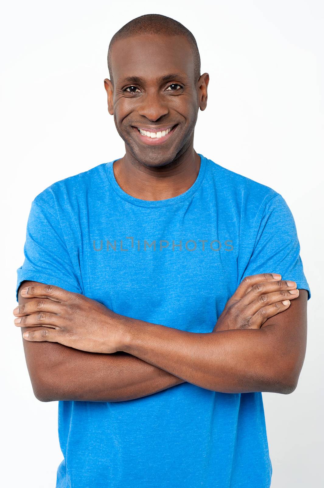 Happy middle aged man posing with folded arms