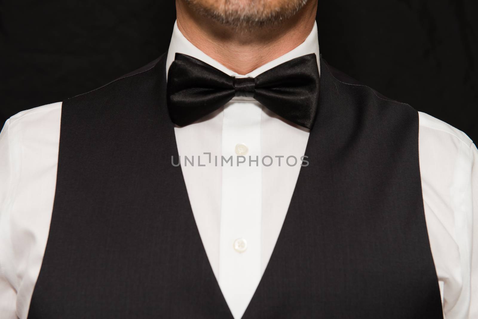 Close-up of gentleman wearing a waistcoat and bowtie.