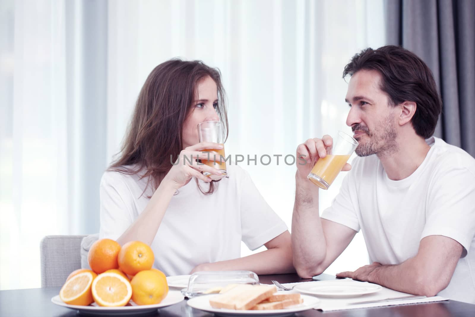 Couple having breakfast together at home 