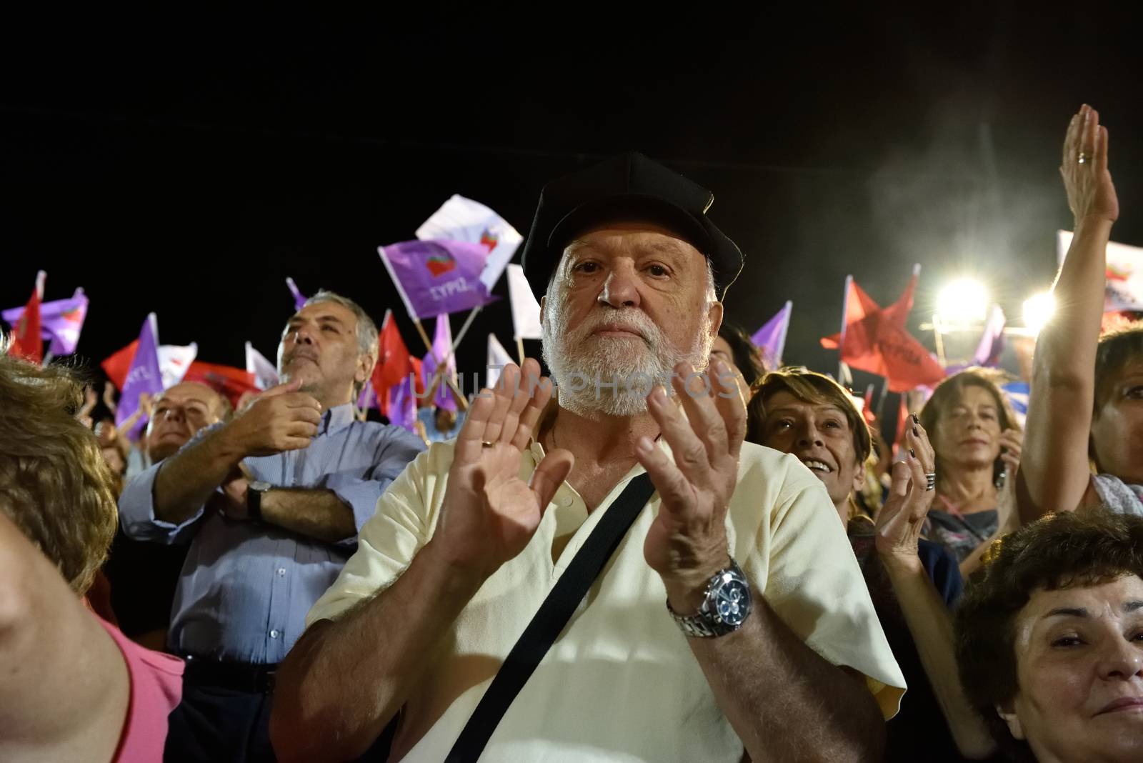 GREECE, Athens: A supporter of the Syriza party applauds during the party's main election campaign rally in Athens, Greece on September 18, 2015. The Greek General Election will be held on September 20