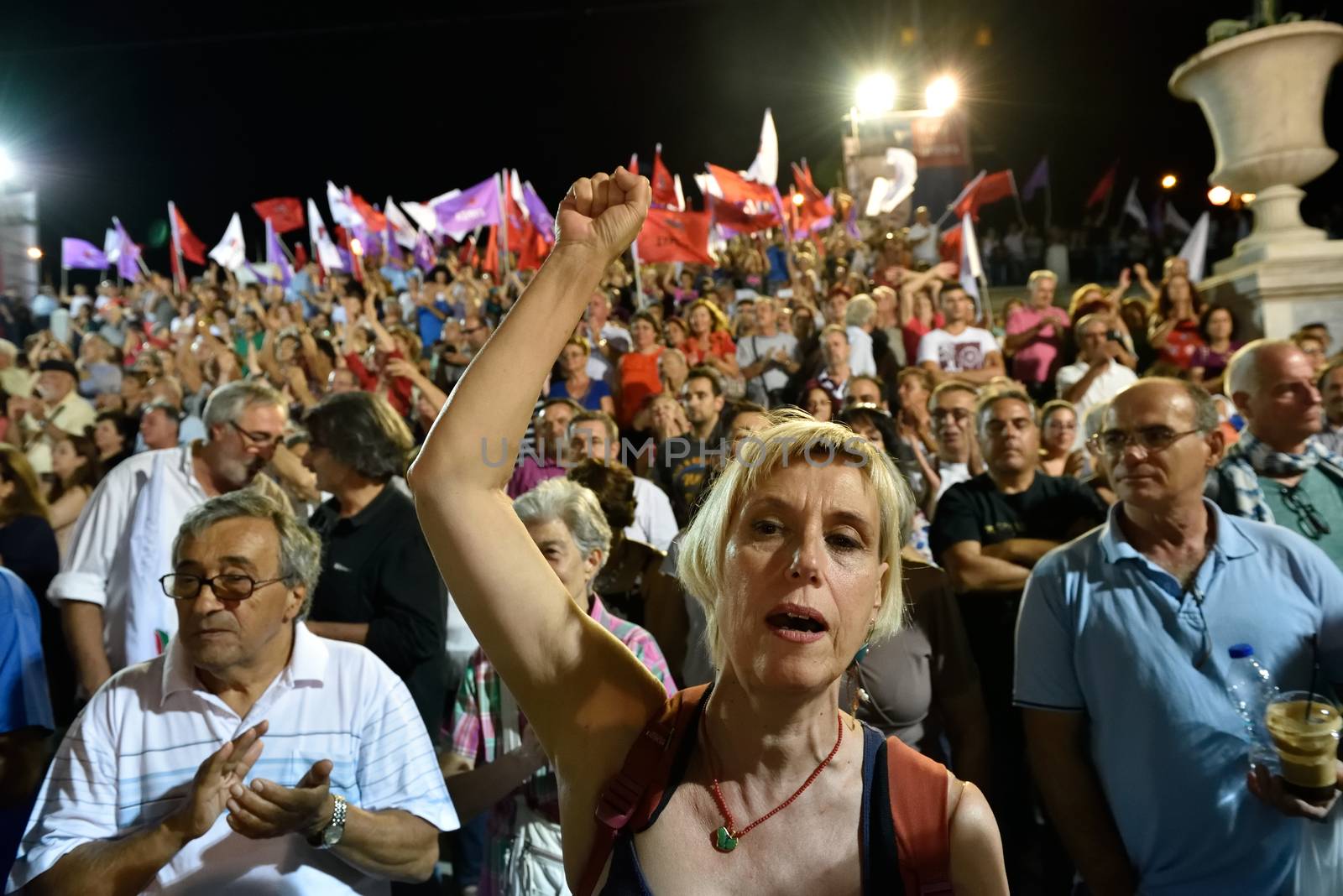 GREECE, Athens: A supporter of the Syriza party pumps her fist during the party's main election campaign rally in Athens, Greece on September 18, 2015. The Greek General Election will be held on September 20