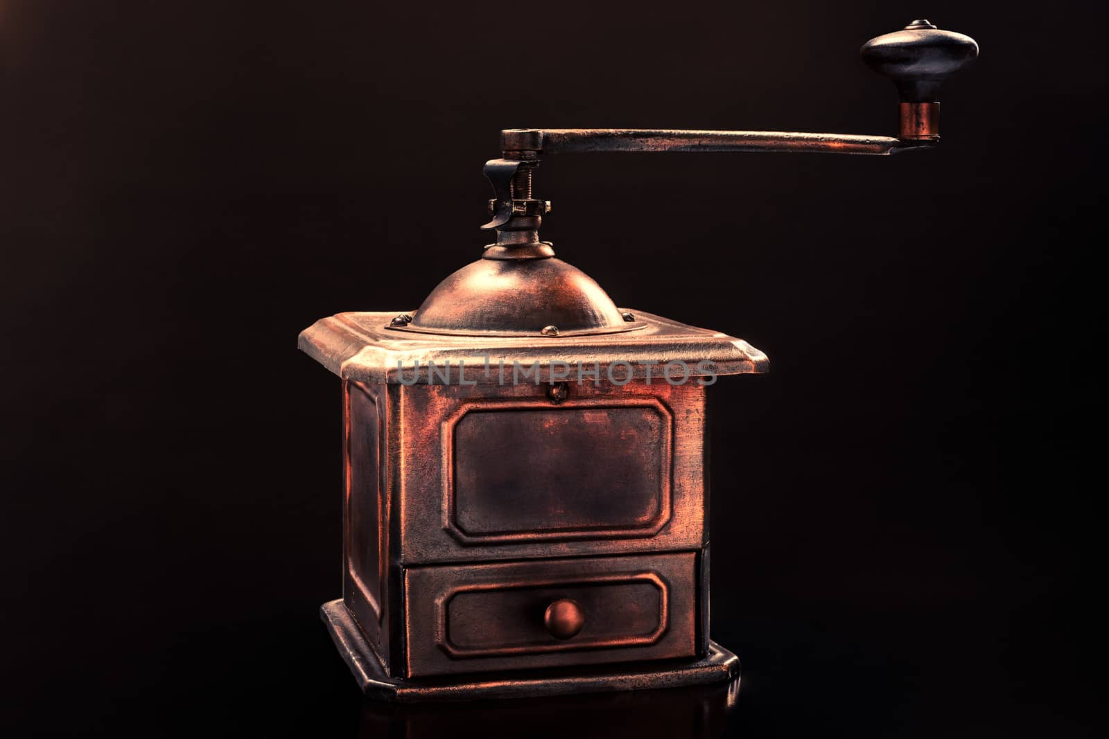 Old coffee grinder on a black background