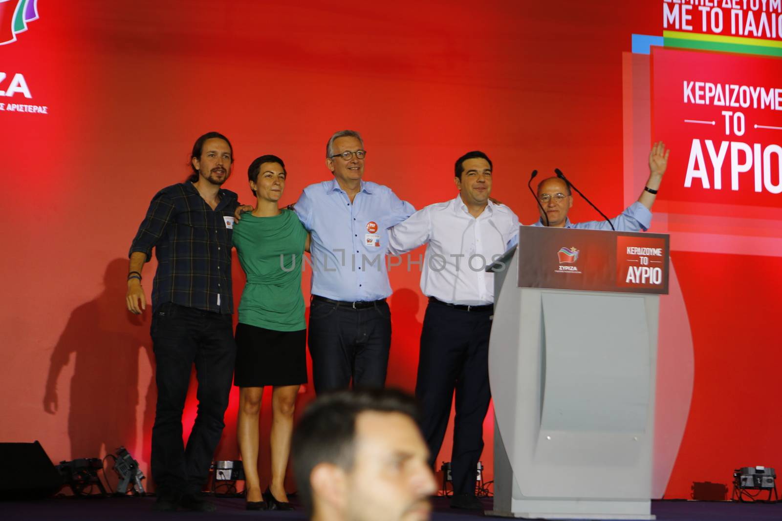 GREECE, Athens: Pablo Iglesias, Ska Keller, Pierre Laurent, Alexis Tsipras and Gregor Gysi (from left to right) embrace and acknowledge the crowd of Syriza supporters during the party's final election rally at Syntagma Square, Athens on September 18, 2015 two days ahead of the Greek General Election