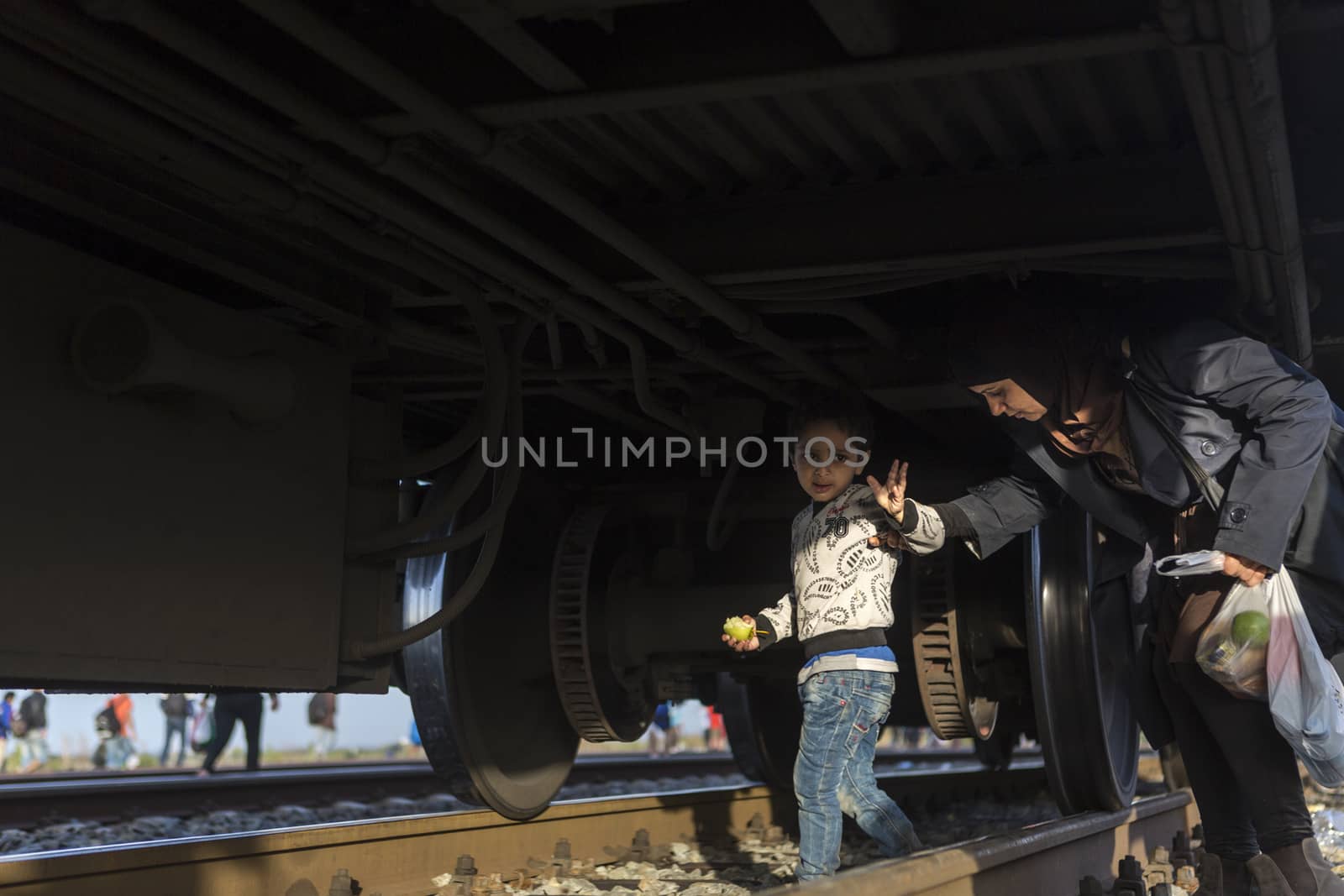 CROATIA, Tovarnik: Refugees attempt to hide under a train at a railway station in Tovarnik, Croatia near the Serbian-border as police move in on their position on September 18, 2015. Refugees are hoping to continue their journey to Germany and Northern Europe via Slovenia  