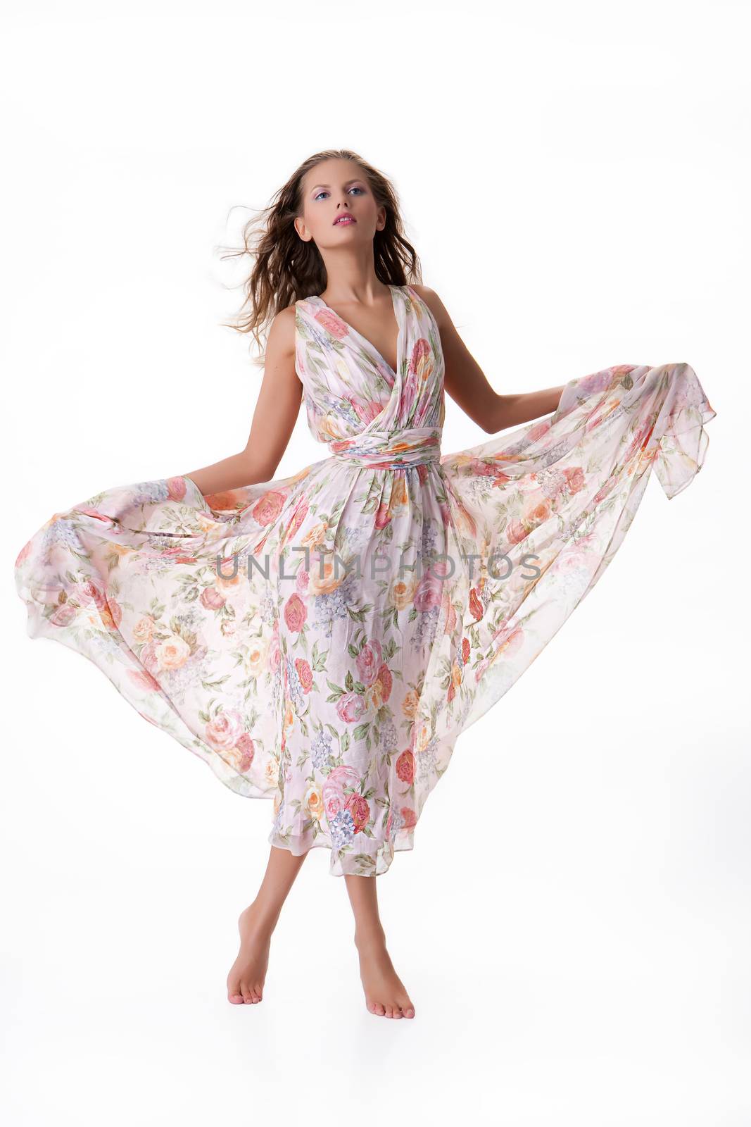 Young beautiful woman in fashinable long dress on isolated background