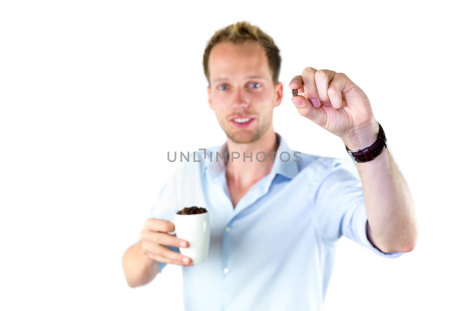 Young salesman holding cup and coffee beans isolated on white background