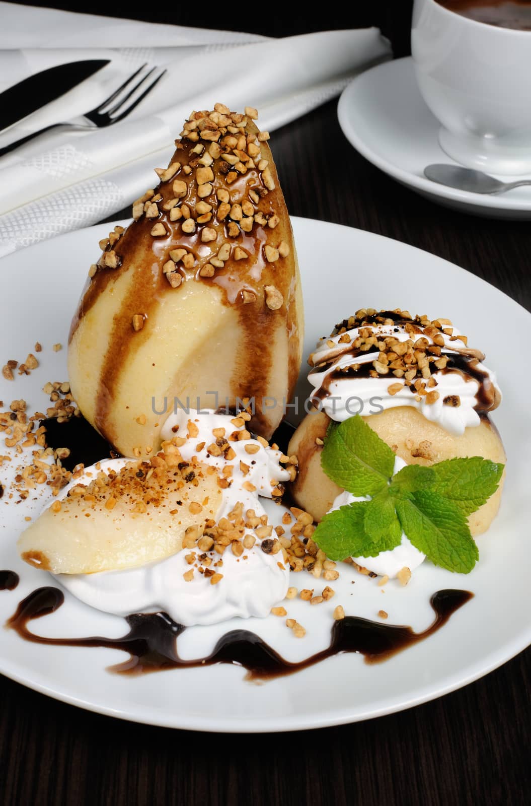 pears with whipped cream sprinkled   nuts,  almonds and chocolate