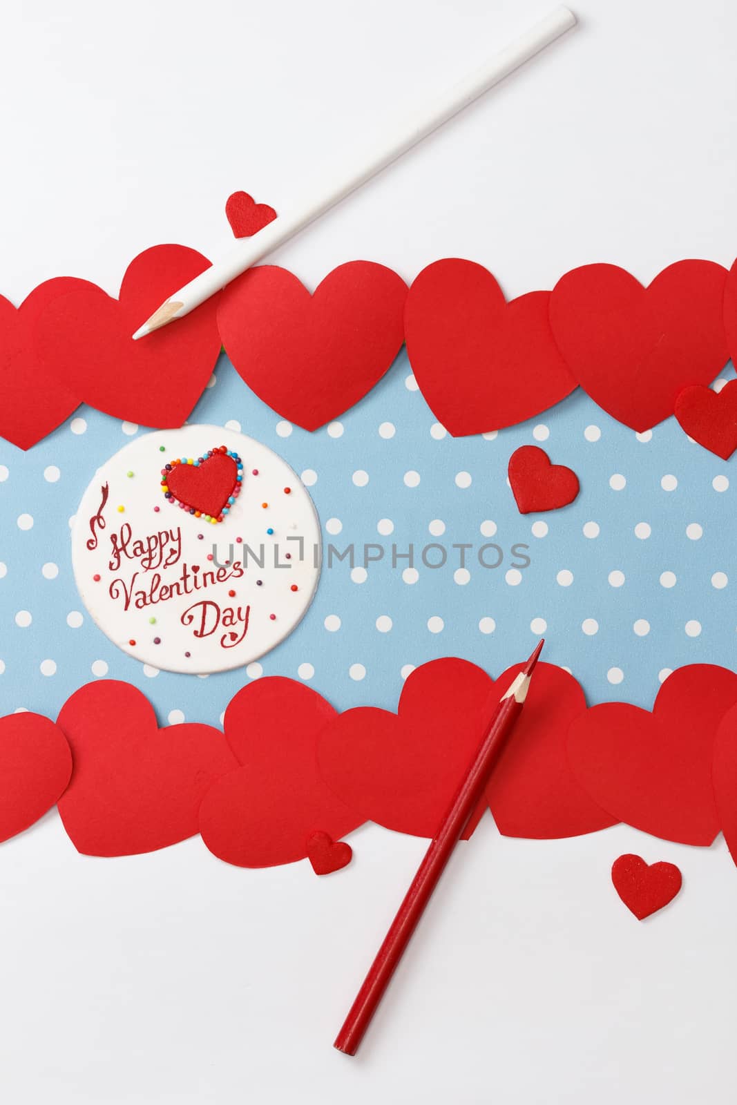 Valentine's day love message, handmade, with pencils and hearts isolated on blue with white dots background (polka dot) with white borders