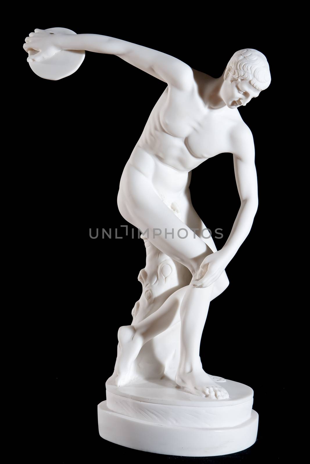 Classical white marble statue of naked discus thrower isolated on black background by mrakor