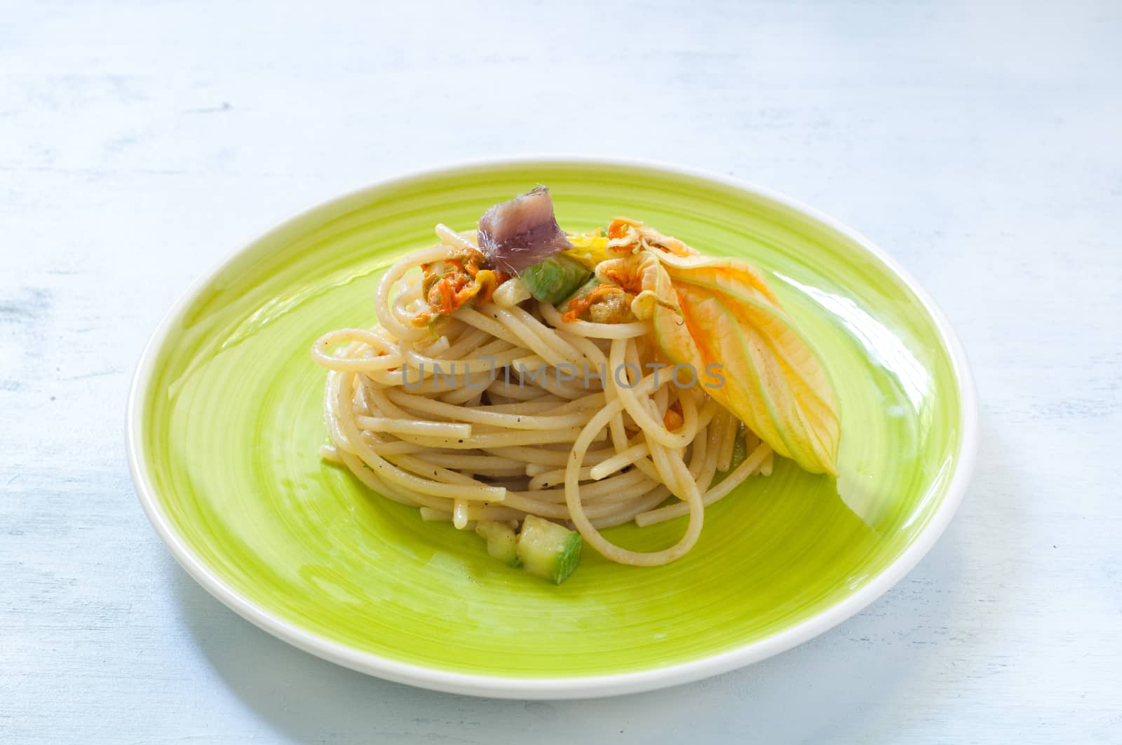 Spaghetti with marinated anchovy, zucchini and zucchini flowers