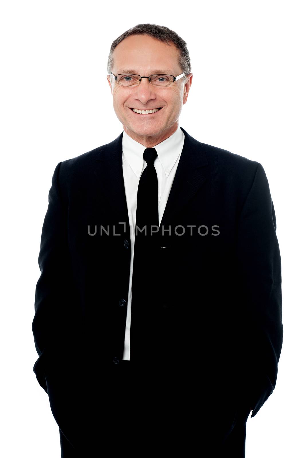 Confident businessman posing with hands in pockets