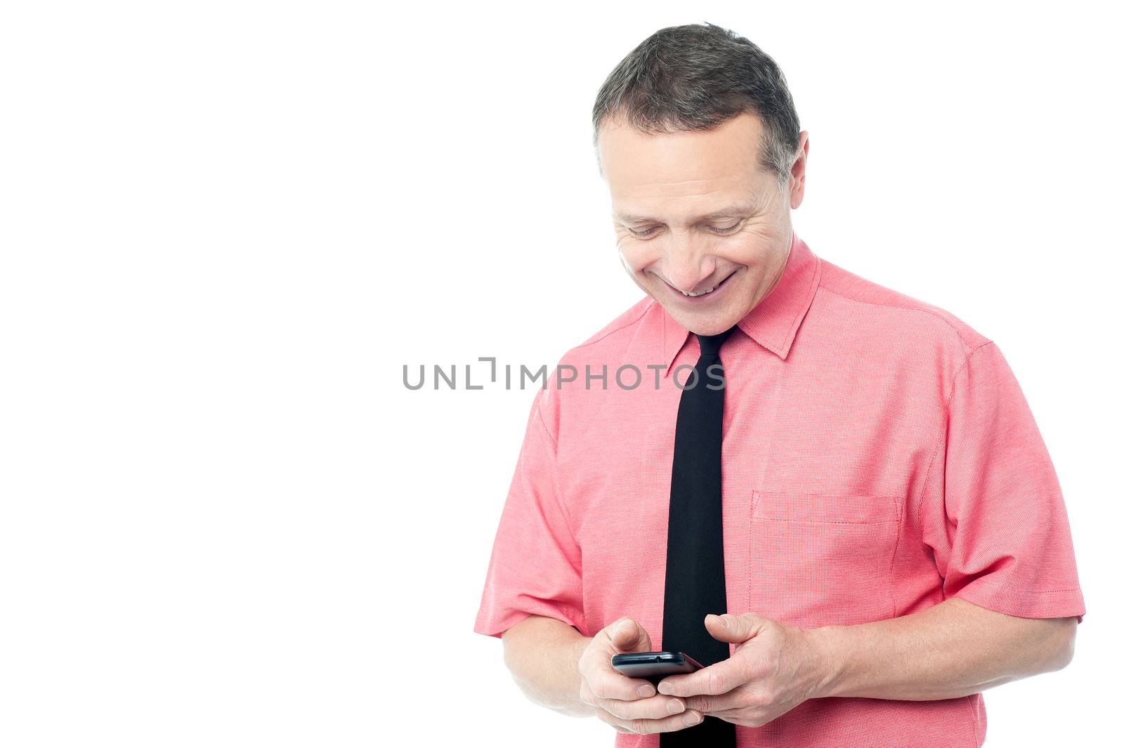 Mature man typing text message on his cellphone