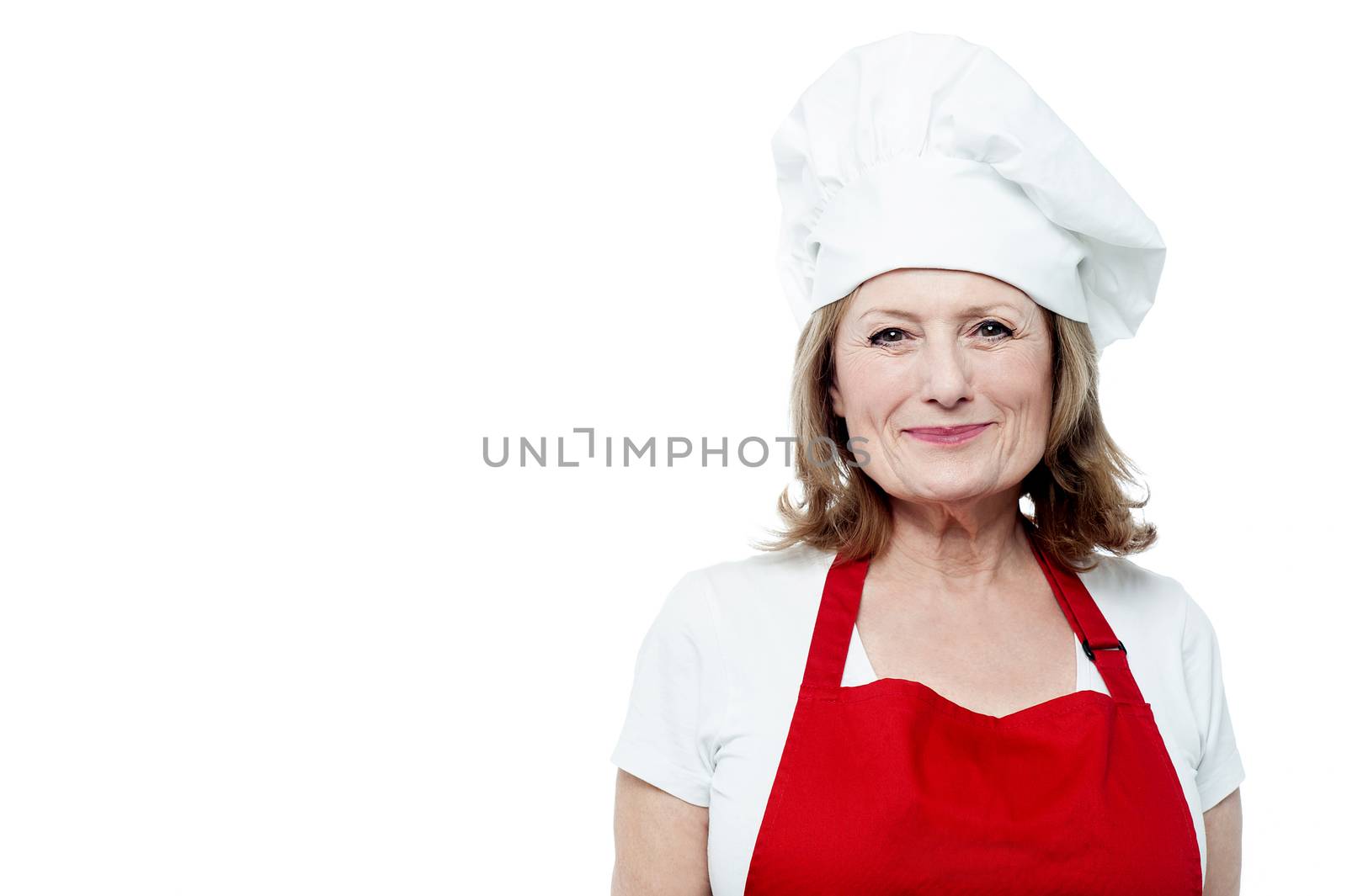 Happy mature female chef posing over white