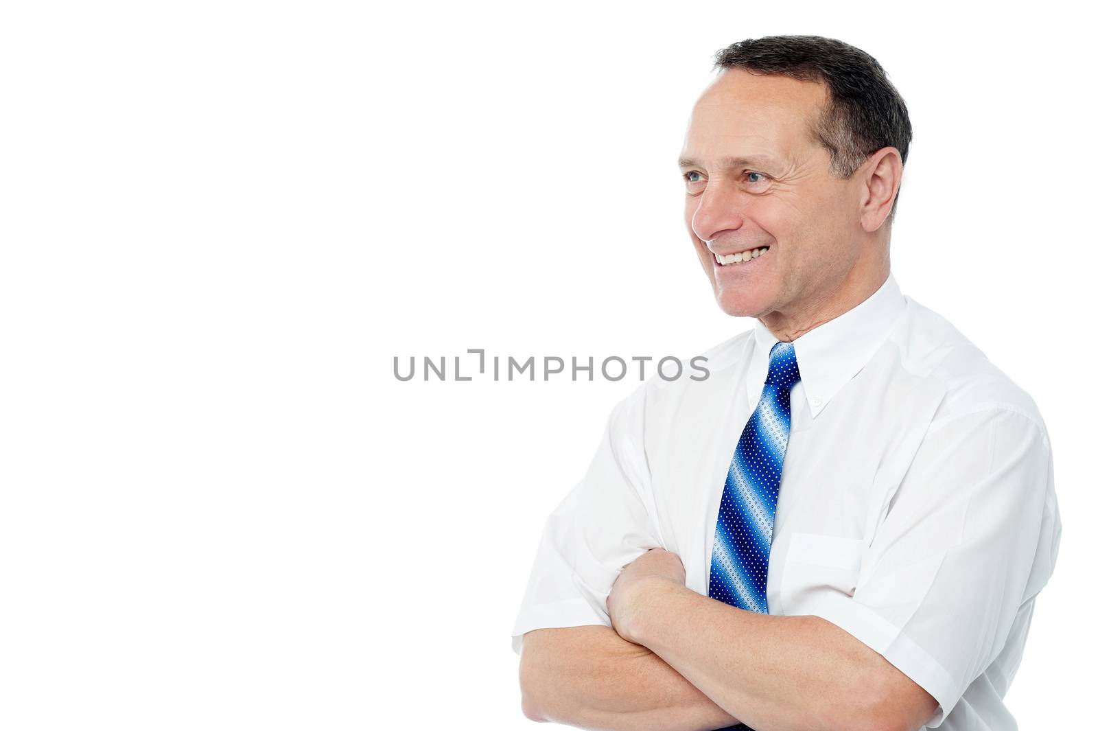 Senior businessman with folded arms and looking away