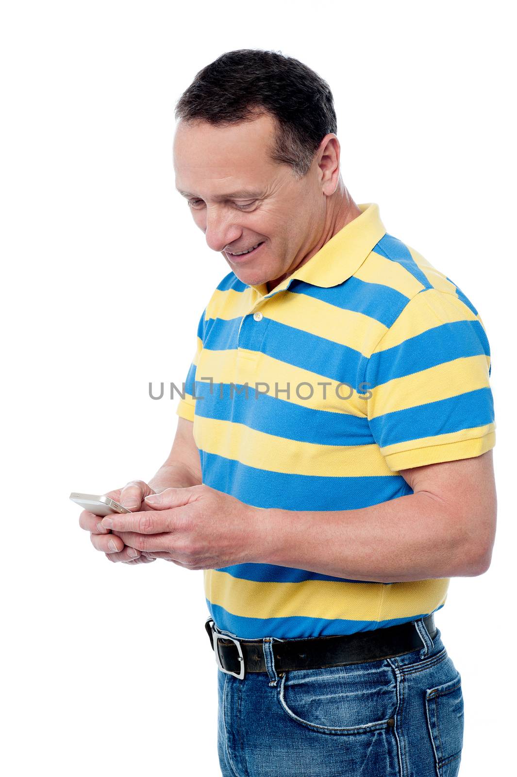 Mature male reading message in his cell phone