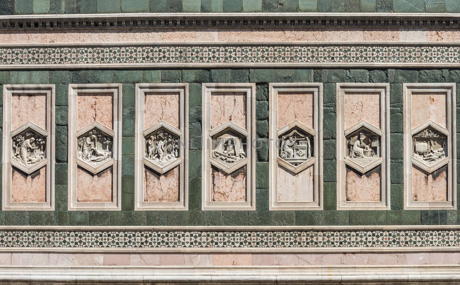 In the picture detail of the Basilica of Santa Maria del Fiore in Florence, a patterns of rectangular statues symmetrical.