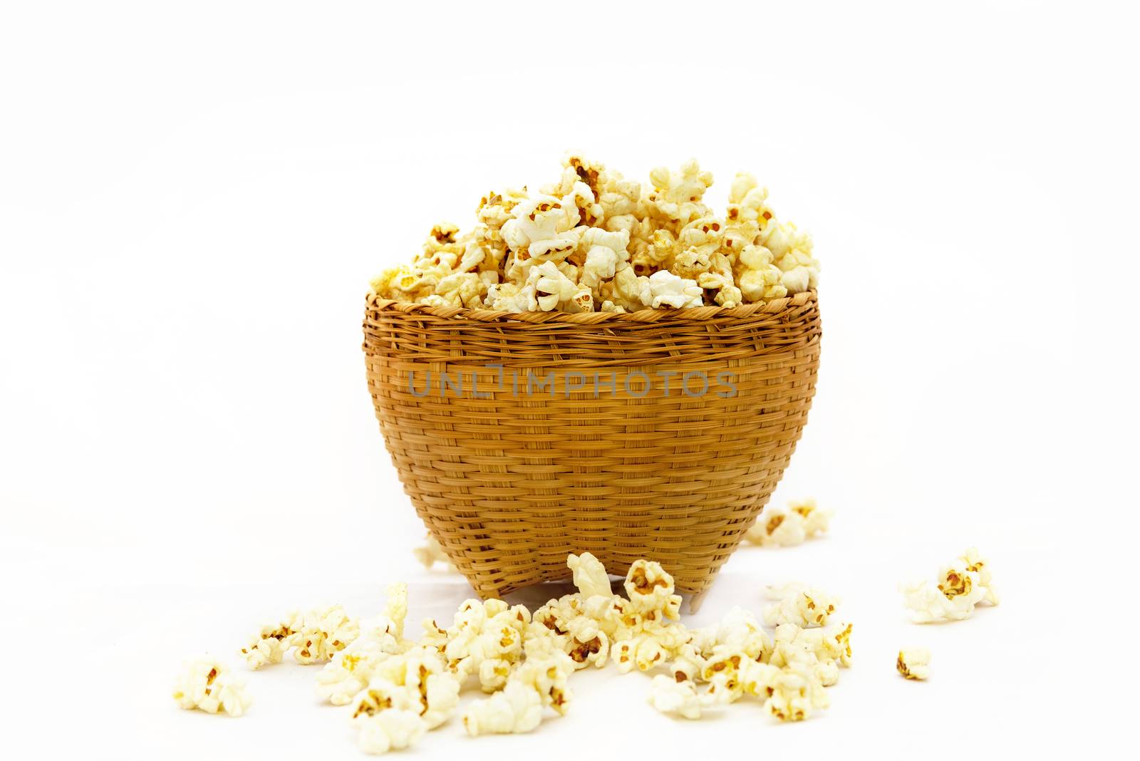 Popcorn in a wooden bucket on white background