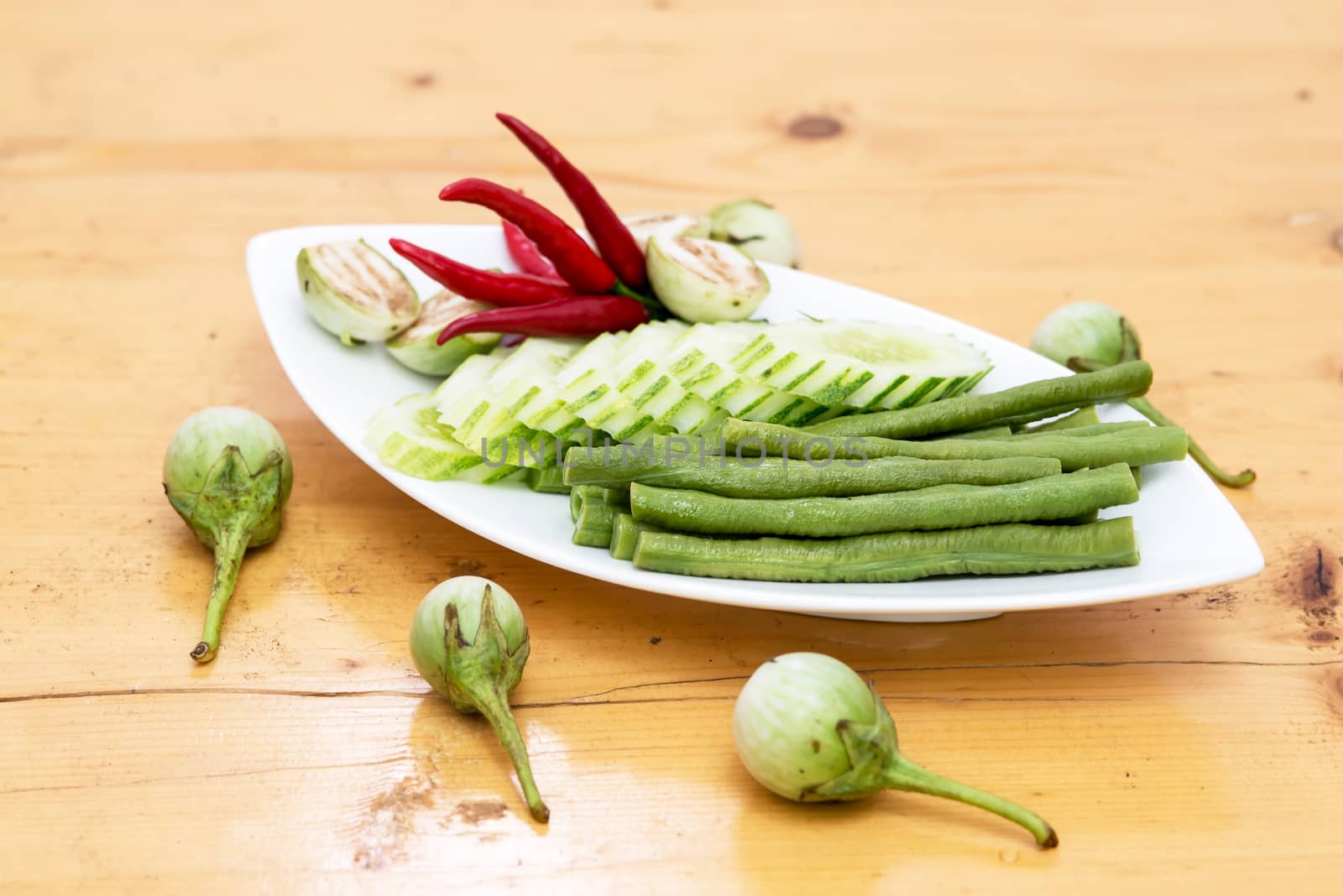 seasonal vegetables in a dish isolated on a white background