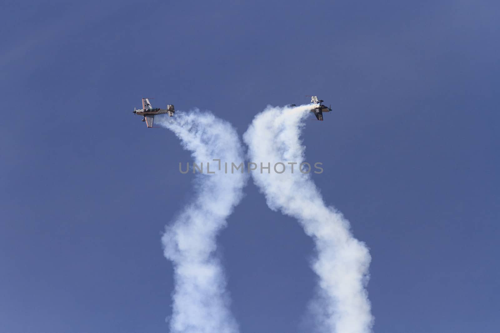 ENGLAND, Southport: Two planes leaves spiral smoke trails during the Southport Airshow 2015 in Southport, Merseyside in England on September 19, 2015