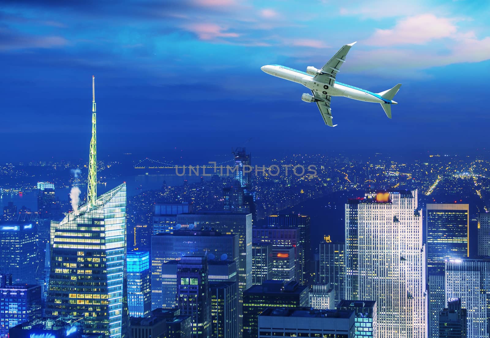 Airplane overflying modern city.
