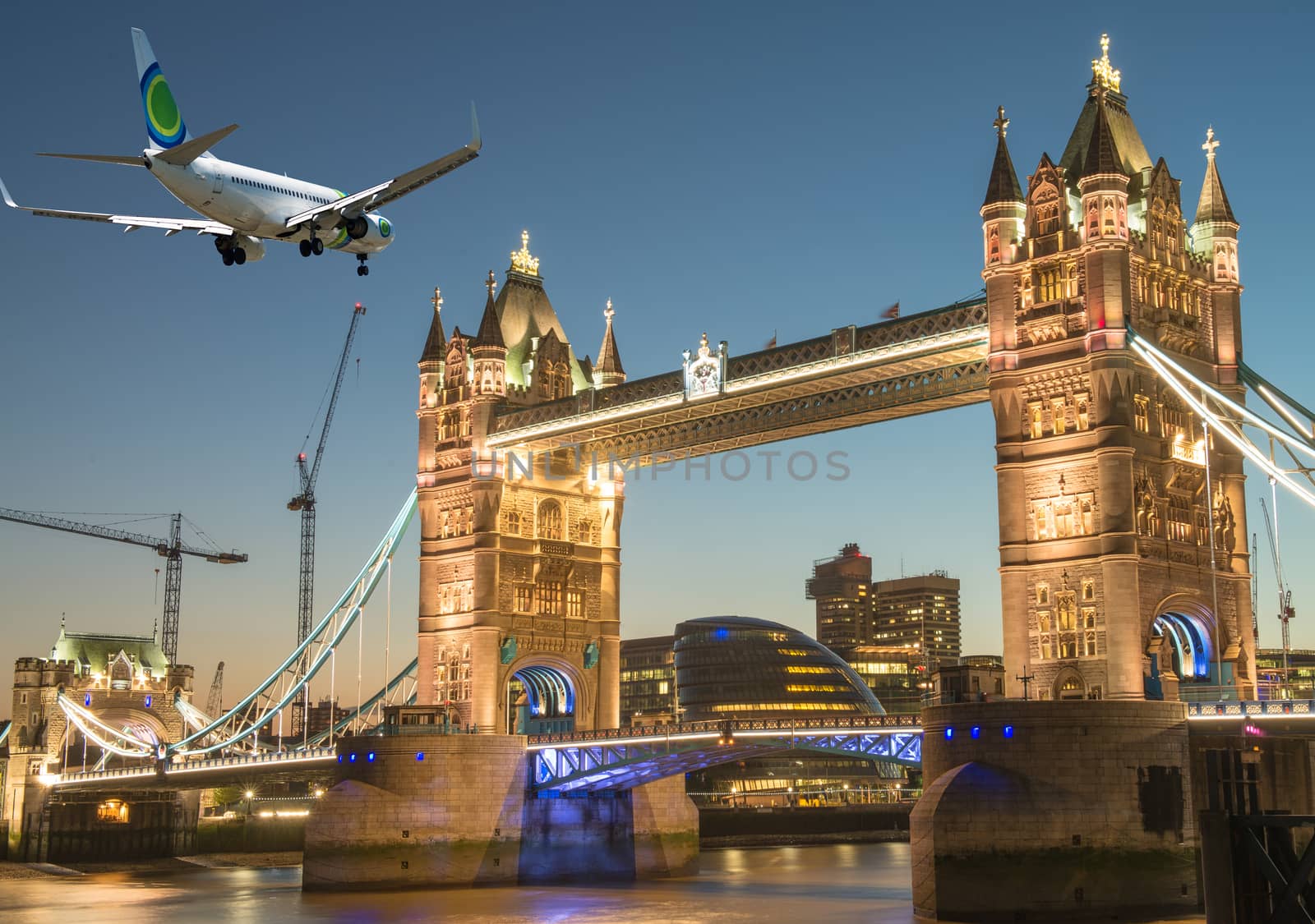 Airplane overflying Tower Bridge in London by jovannig