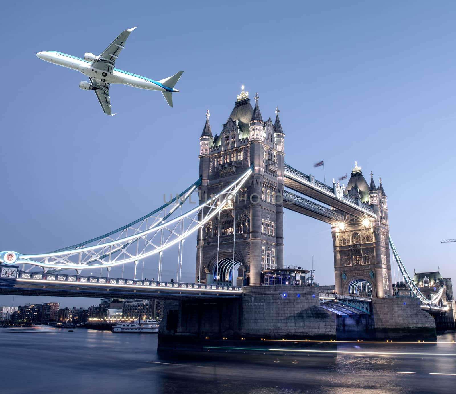 Airplane overflying Tower Bridge in London.