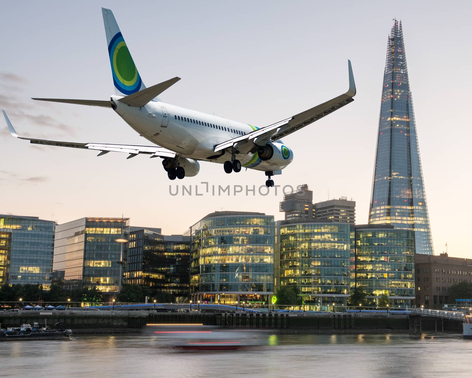 Airplane overflying London - Tourism and vacation concept by jovannig