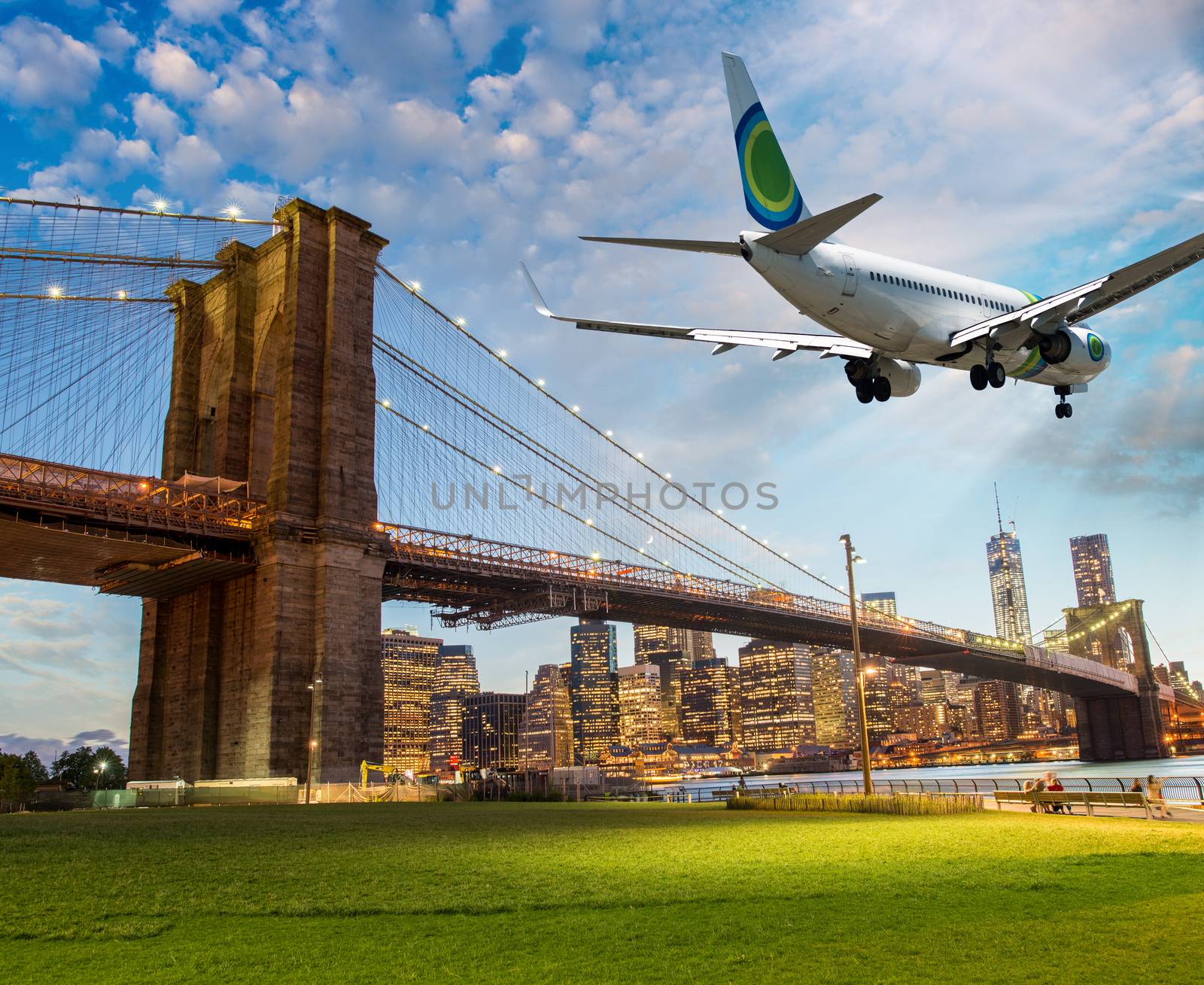 Airplane overflying Brooklyn Bridge in New York City.